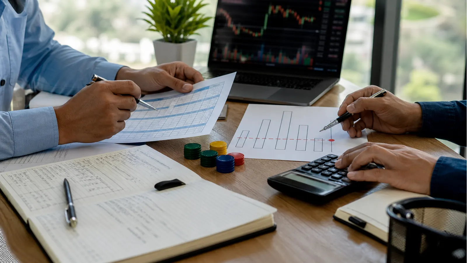 A financial advisor and investor reviewing a trading journal, calculator and risk worksheet before deciding a stop-loss level and trade size.